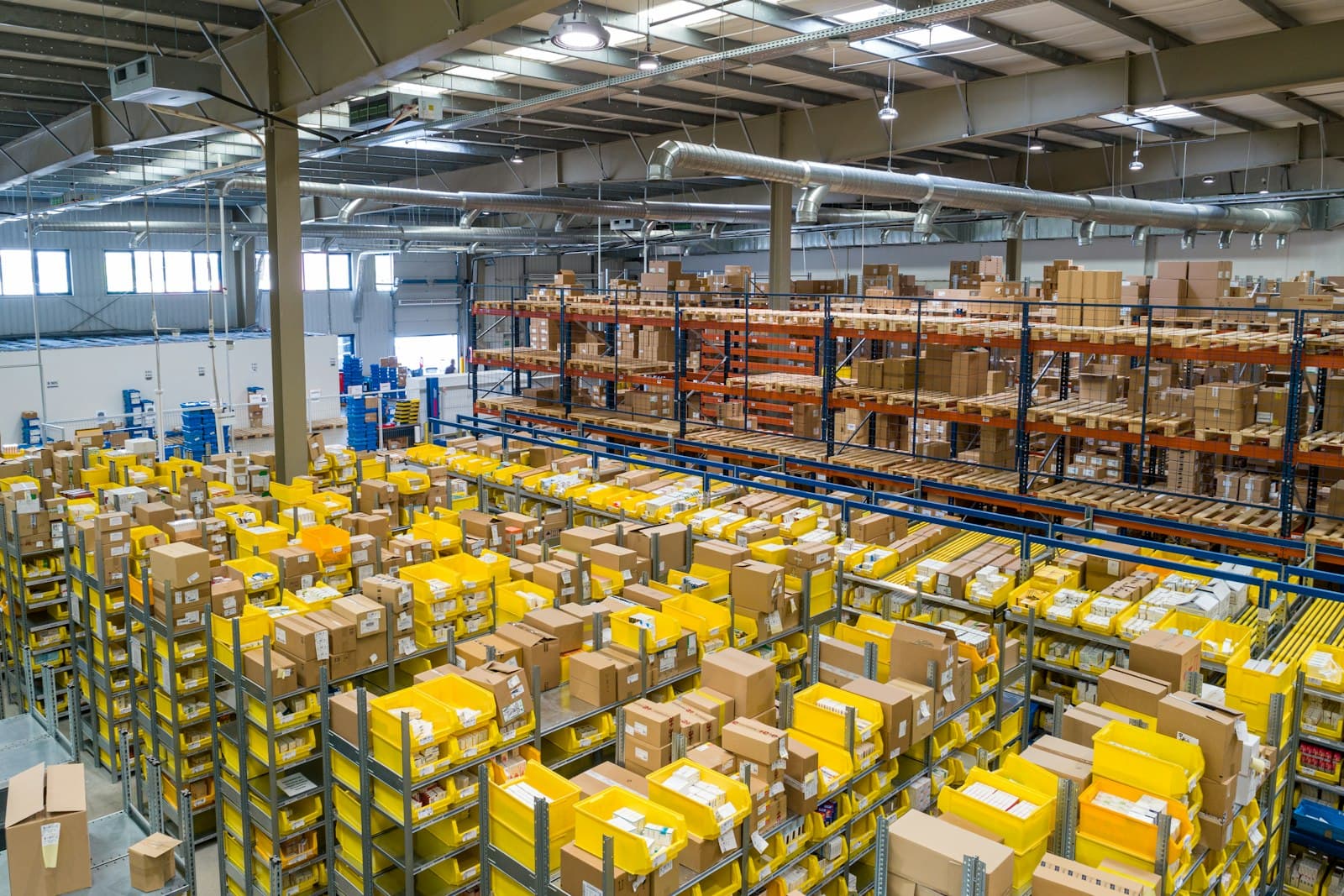 Logistics warehouse aisle where inventory must connect to finance ledgers