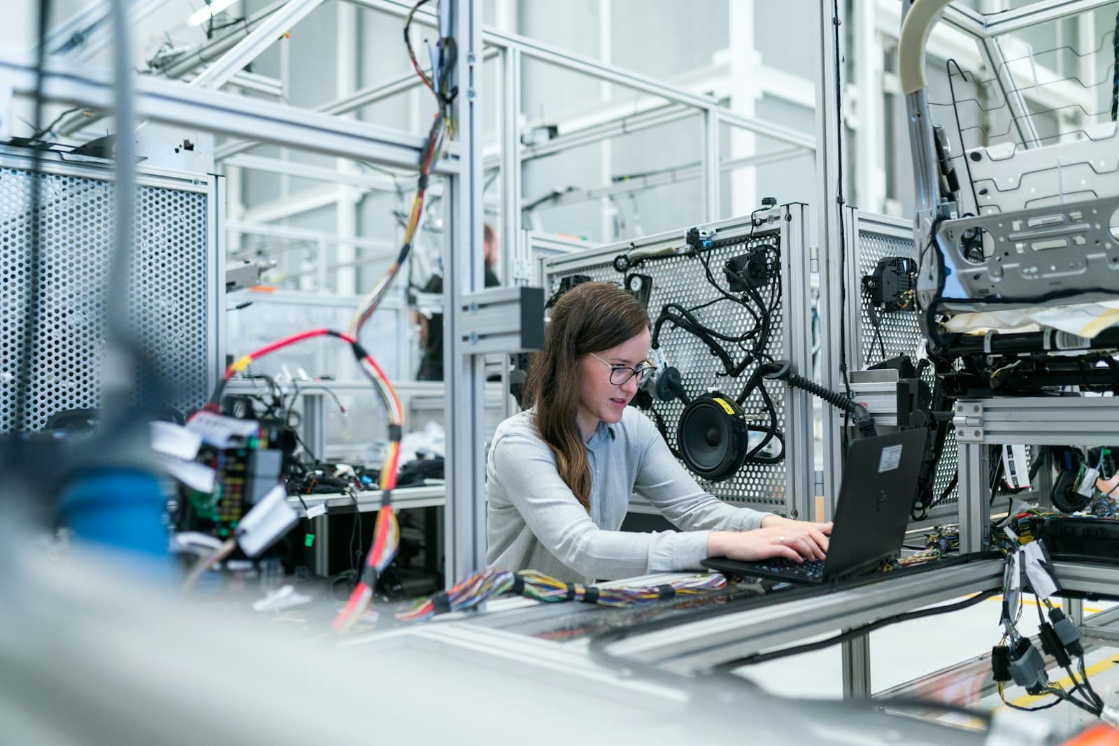 Manufacturing engineer reviewing shop-floor systems linked to ERP finance