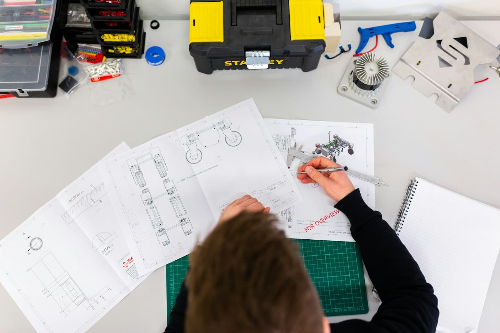 Manufacturing engineer reviewing industrial system drawings and OT controls