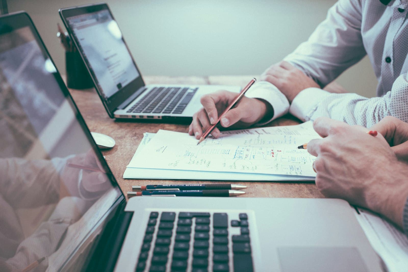 Healthcare administrators processing procurement and insurance paperwork